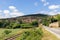 View of Peyre village,Â Church of St. Christopher and old railroad track from country road D41. Compregnac, Aveyron